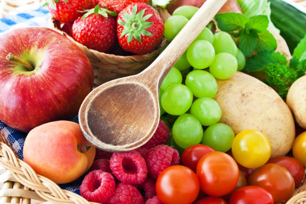 istock Fruits and vegetables with wooden spoon 1154938765