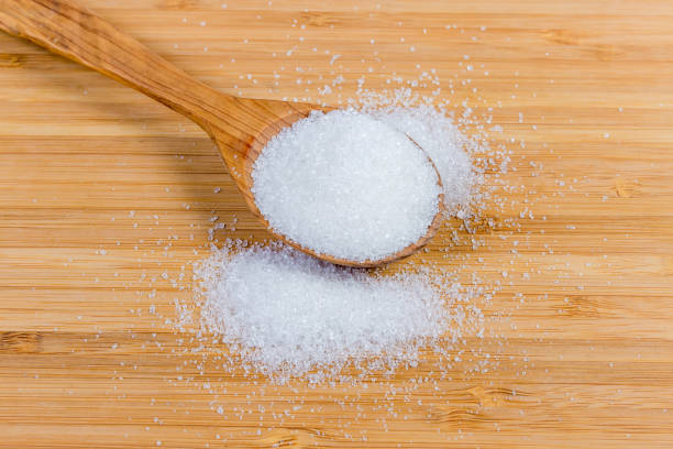 istock White sugar in wooden spoon and beside on wooden surface 1154939113