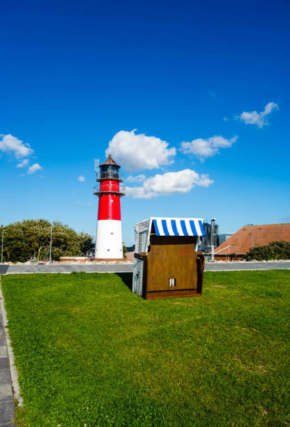 istock Lighthouse in Husum with beach chair on the Nordssee 1154940789