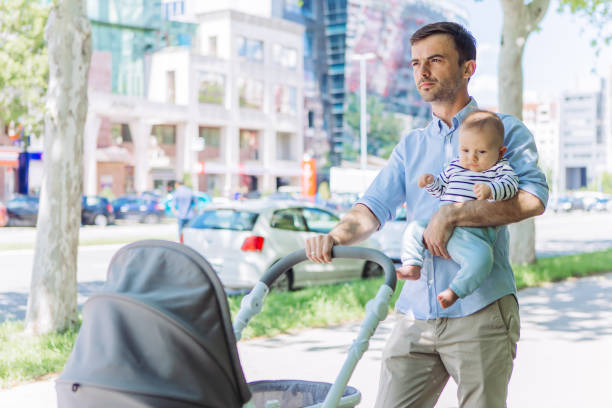 istock Father and baby son walking 1154940802