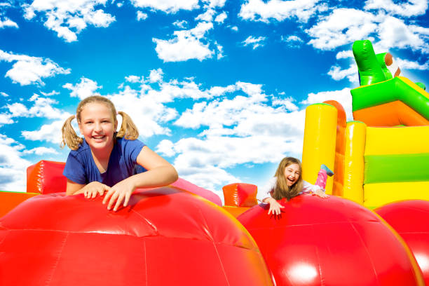 istock Happy Girls on Inflate Castle 1154940817