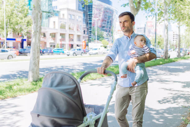 istock Father and baby son walking 1154941724