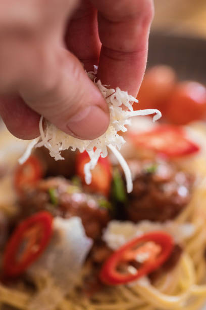 Spaghetti with meatballs, grated parmesan, close-up