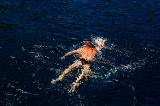 istock Man floats by sea 1154942457