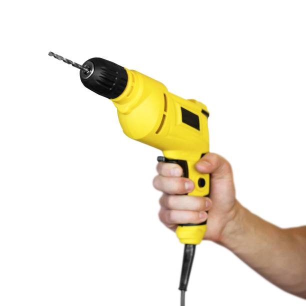istock Hand holding a yellow electric drill. Close up. Isolated on white background 1154942662