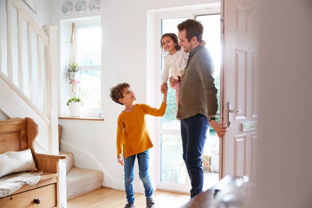 istock Single Father Returning Home After Trip Out With Excited Children Running Ahead 1154943259