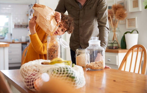 istock Father Helping Son To Refill Food Containers At Home Using Zero Waste Packaging 1154945374
