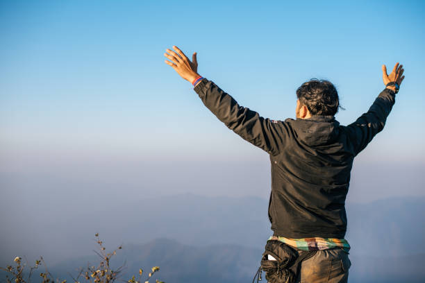 istock Man traveling with backpack hiking in mountains 1154946618