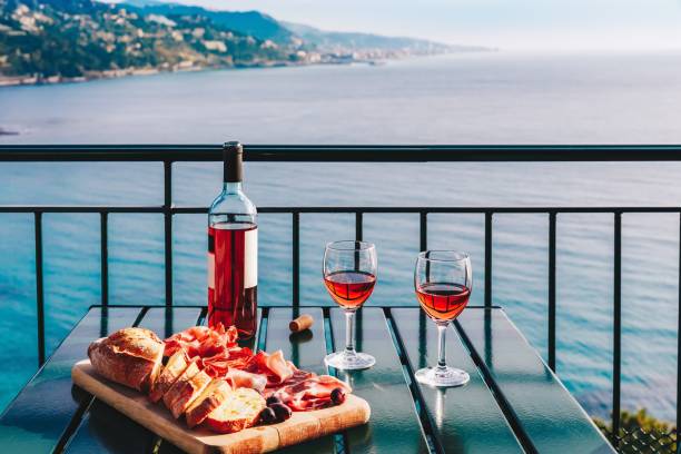 Two glasses of wine and italian snacks  with amazing view at sunset in Italy. Two glasses of wine and italian snacks  with amazing view at sunset in Italy. Romantic dinner for two on panoramic terrace wine italian culture wine bottle bottle stock pictures, royalty-free photos & images