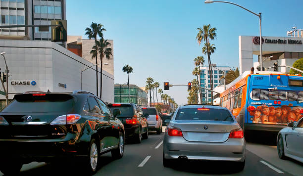 View of rush hour on Wilshire boulevard in Los Angeles, California. View of rush hour traffic in Wilshire Boulevard, a Los Angeles surface street that runs from downtown LA to the Pacific ocean in Santa Monica, California. los angeles traffic jam stock pictures, royalty-free photos & images