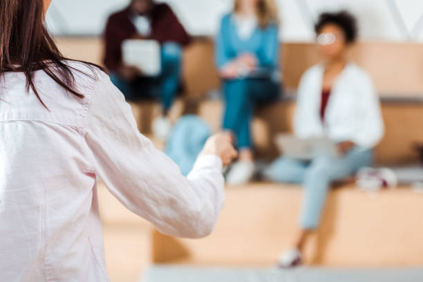 istock selective focus of students listening teacher in lecture hall 1154947662