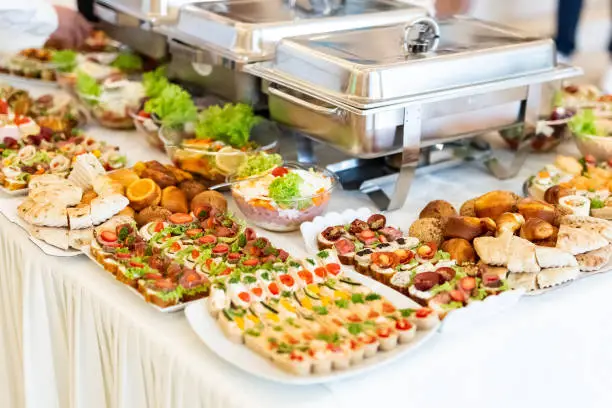 Catering buffet table with canapes, salads and bread.