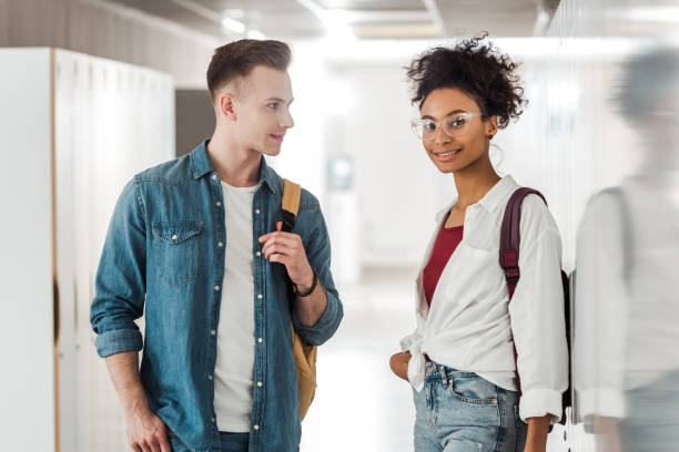 istock two multiethnic students standing in corridor in university 1154947939