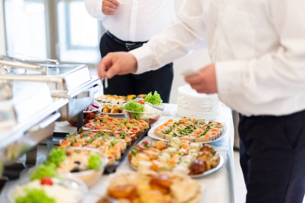 istock Waiters serving buffet canapes on table. Food and celebration concept. 1154948944