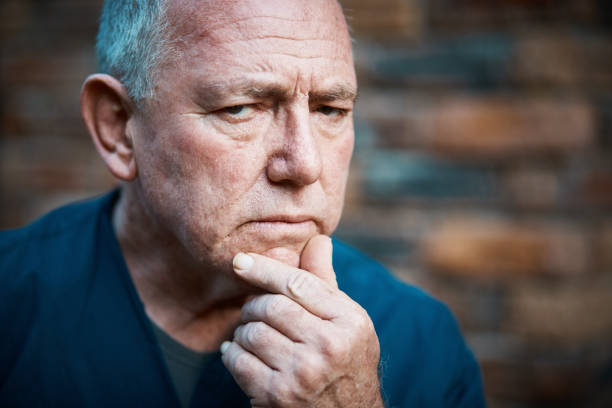 istock Serious senior man looking suspicious 1154950417