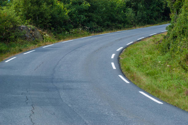 istock Tight curve in a narrow road. 1154950594