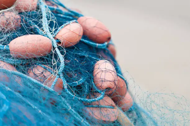 Photo of Blue fishing nets with floats.