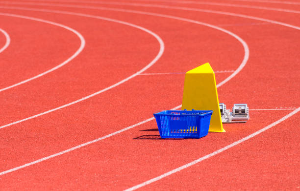 Athletic stadium with running-tracks and start blocks Athletic stadium with running-tracks and start blocks heptathlon stock pictures, royalty-free photos & images