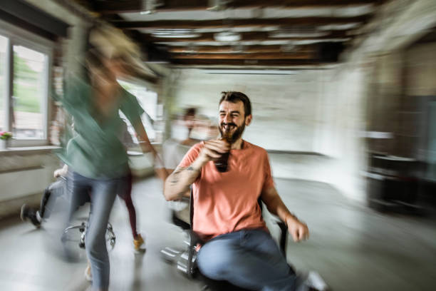 istock Cheerful man drinking beer while having fun on a chair in blurred motion. 1154958262