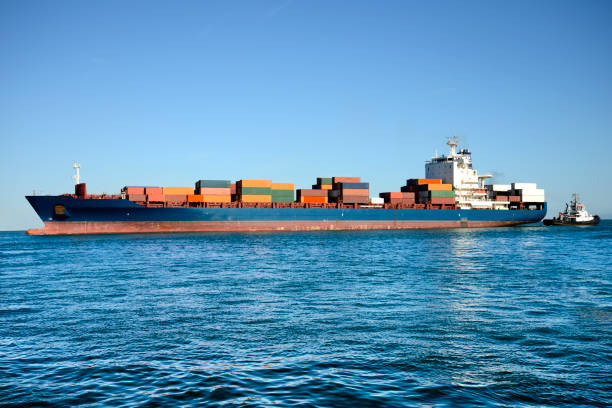 istock Ship and tugboat in the harbor 1154958264