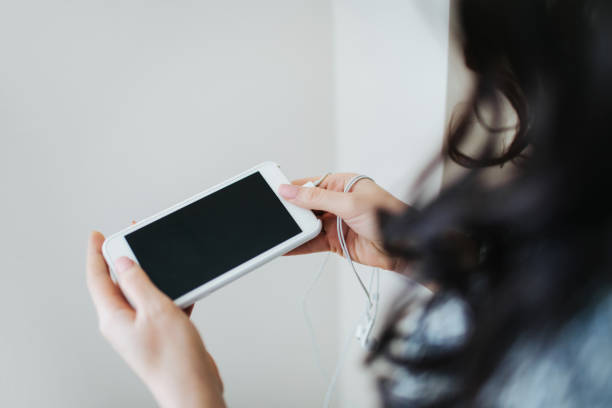 istock Young woman holding white smartphone. 1154959037