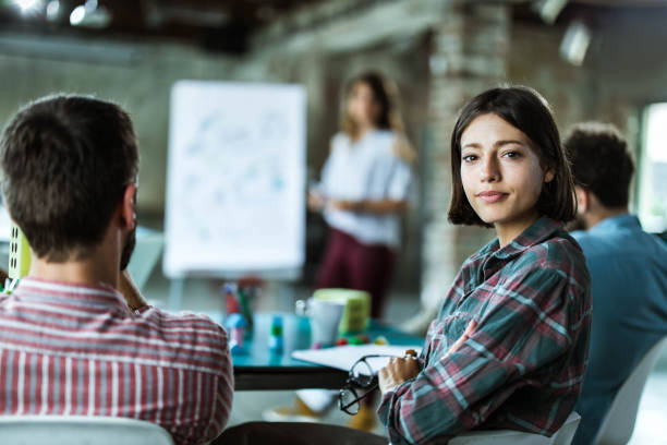 istock Creative woman on a presentation with her colleagues in the office. 1154959131