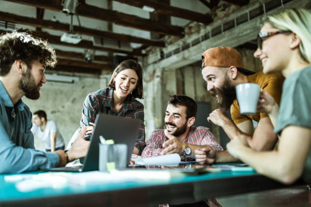 istock Happy creative team talking about reports during a meeting at casual office. 1154959373