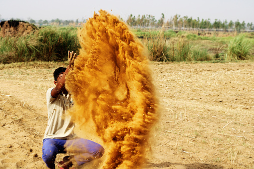 Children playing in desert using sand.