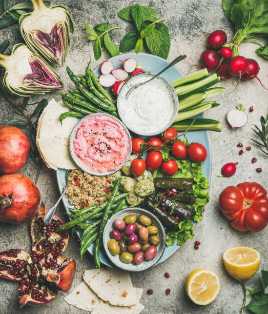 istock Vegetarian snack and dip board over concrete table background 1154961232