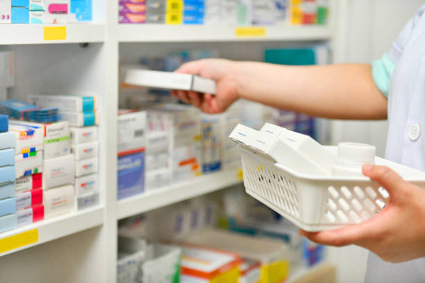 Pharmacist filling prescription in pharmacy store stock photo