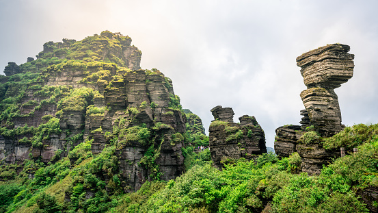 Mushroom shaped stone and view of the old golden summit in Fanjing mountain in Guizhou China