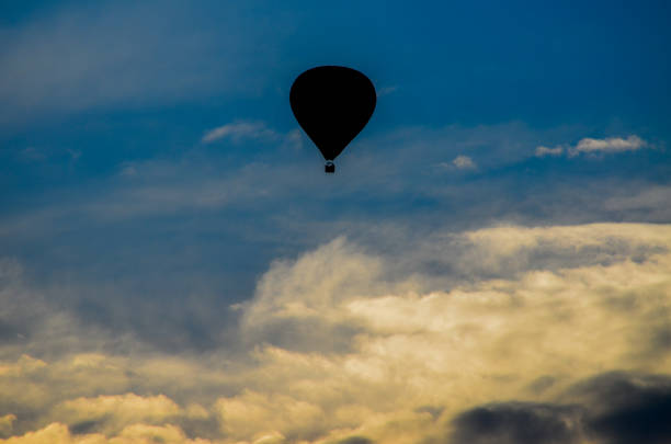 istock Hot air balloon on blue and yellow sky 1154962904