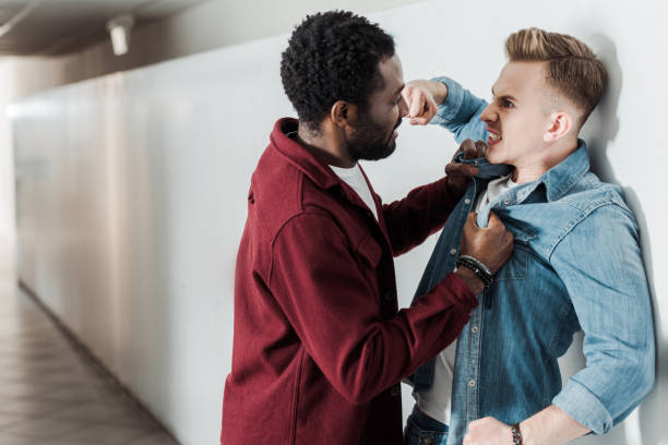 istock two multiethnic students fighting in corridor in college 1154963587