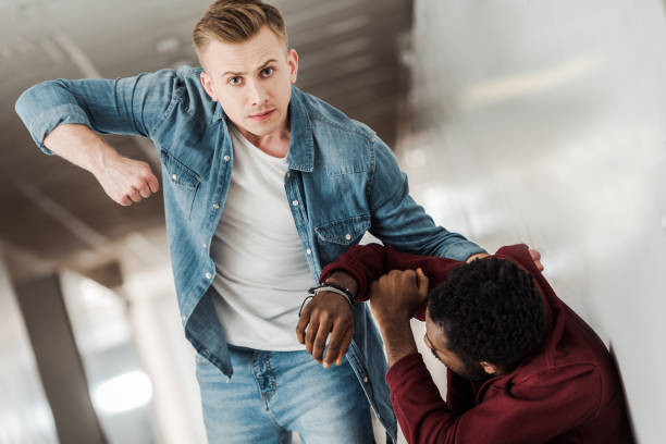 istock two students in jeans fighting in corridor in college 1154963620