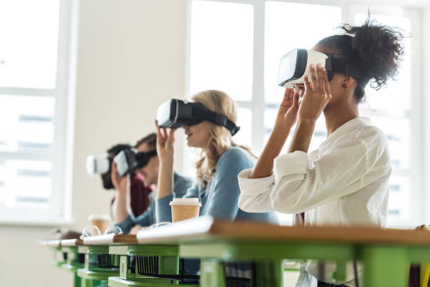 selective focus of multiethnic students using vr headsets in university selective focus of multiethnic students using vr headsets in university virtual college education stock pictures, royalty-free photos & images