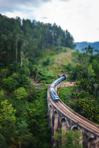 Photo of Train on the Nine Arch Bridge in Sri Lanka. Travel to Ceylon island, popular travel  destination in Asia