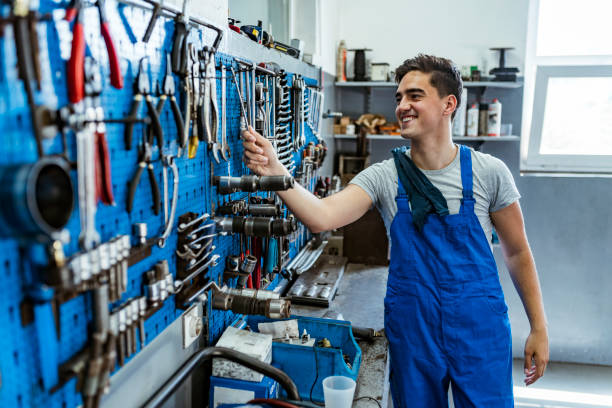 istock Young man standing in factory workshop 1154965079