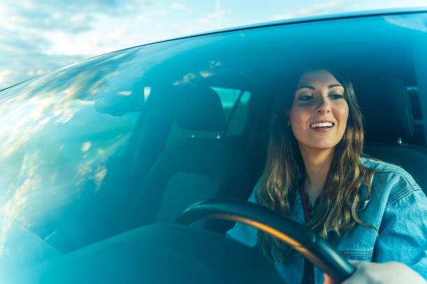 istock Young woman driving a car 1154965230