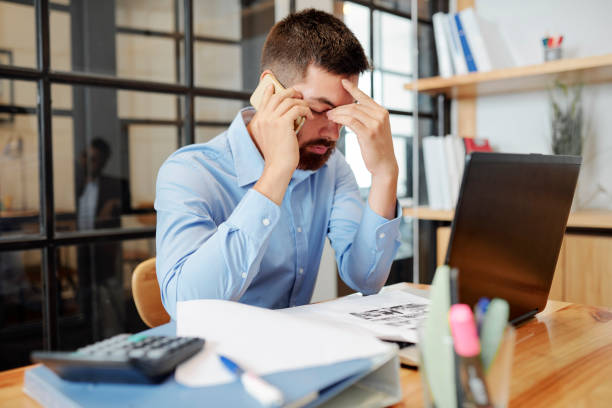 istock Tired businessman working at the table 1154969041