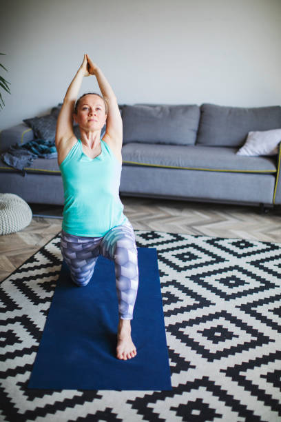 istock Woman practicing yoga at home 1154969138