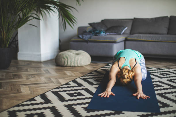 istock Woman practicing yoga at home 1154969139
