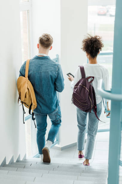istock back view of two international students with backpacks 1154970970