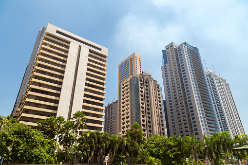 buildings and skyscrapers in Ortigas, Manila, Philippines, with blue sky on background