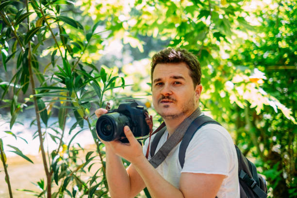 istock Young Man Taking Pictures in Nature 1154972422