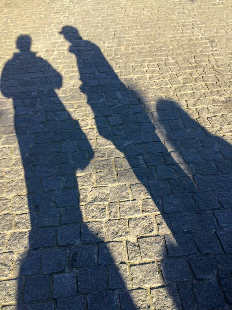 istock Silhouette of walking people 1154972585