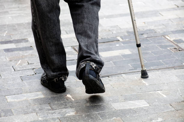 istock Senior man walking with crutch 1154975841