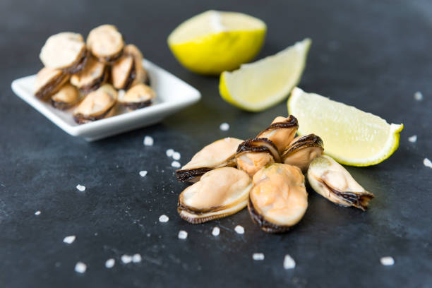 istock pickled mussels with lime and coarse salt on a black background 1154977311