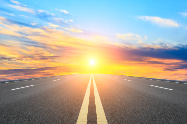 istock Straight asphalt road and sunset sky 1154977522