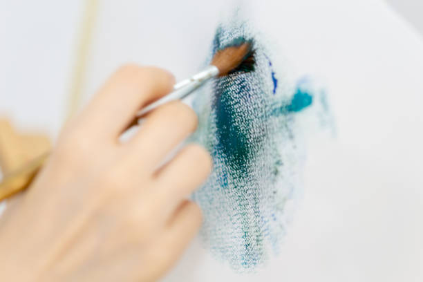Artist's brush stroke on canvas while painting, closeup