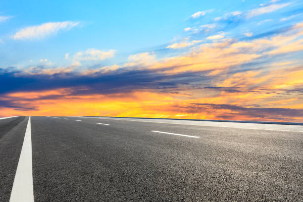 istock Asphalt road and sunset sky 1154977965